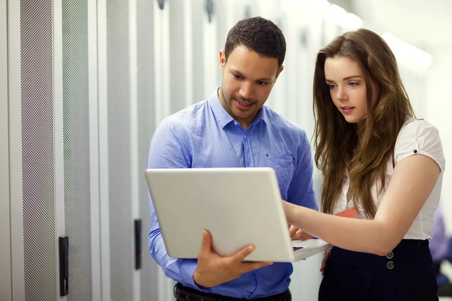 PC Repair Professional Working With A Young Office Worker To Fix Laptop That Has A Virus